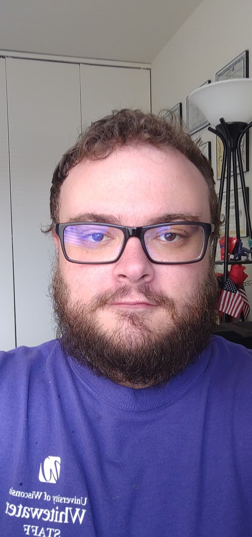 Picture of me, Lance Ryan. 27 Year old white male with brown hair and a beard. Thick rimmed black rectangular glasses. Wearing a purple shirt.